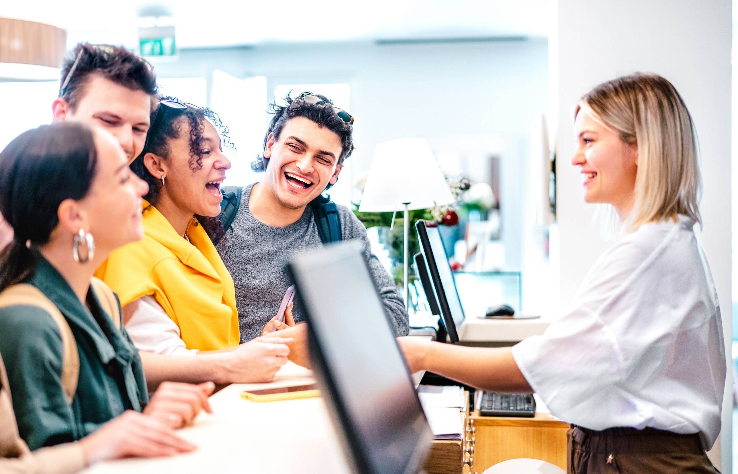 Hospitality Student at Front Desk with Guests